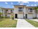 Two-story townhome featuring balconies, a one car garage, and neutral siding at 6343 92Nd N Pl # 2102, Pinellas Park, FL 33782