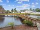 Exterior photo of community bridge with gazebo, wood railing, and tranquil water views at 6343 92Nd N Pl # 2102, Pinellas Park, FL 33782