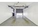 Spacious garage with overhead racks for storage and painted concrete floors at 6343 92Nd N Pl # 2102, Pinellas Park, FL 33782