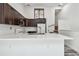 Charming kitchen with quartz counters, dark cabinets, stainless sink, and a stylish subway tile backsplash at 6343 92Nd N Pl # 2102, Pinellas Park, FL 33782