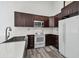 Spacious kitchen featuring stainless appliances, white subway tile, granite counters, and dark wood cabinets at 6343 92Nd N Pl # 2102, Pinellas Park, FL 33782