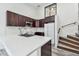 Charming kitchen with quartz counters, stainless sink, dark cabinets and a stylish subway tile backsplash at 6343 92Nd N Pl # 2102, Pinellas Park, FL 33782