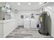 Finished laundry room with gray floors, water heater and white washer and dryer at 6343 92Nd N Pl # 2102, Pinellas Park, FL 33782