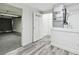 Laundry room showing access to garage and gray laminate floors at 6343 92Nd N Pl # 2102, Pinellas Park, FL 33782