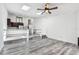 Bright living room featuring skylights, modern flooring, and a view of the kitchen at 6343 92Nd N Pl # 2102, Pinellas Park, FL 33782