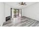 Cozy living room with wood floors, ceiling fan and a sliding glass door leading to an outdoor balcony at 6343 92Nd N Pl # 2102, Pinellas Park, FL 33782