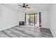 Bright living room with wood floors, ceiling fan and a sliding glass door leading to an outdoor balcony at 6343 92Nd N Pl # 2102, Pinellas Park, FL 33782