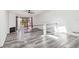 Bright living room with gray wood floors, a ceiling fan, and a sliding glass door to a patio at 6343 92Nd N Pl # 2102, Pinellas Park, FL 33782