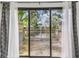 A tranquil view of the water from a wooden patio with white and grey patterned curtains at 6343 92Nd N Pl # 2102, Pinellas Park, FL 33782