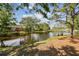 Scenic water view, framed by lush trees and greenery, reflecting the clear blue sky at 6343 92Nd N Pl # 2102, Pinellas Park, FL 33782