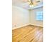 This bedroom has wood floors, a ceiling fan, and a bright window at 717 Cordova Green, Seminole, FL 33777