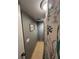 Hallway leading to bathroom with gray walls and tasteful nautical themed decor at 717 Cordova Green, Seminole, FL 33777