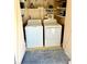Bright laundry room with Hotpoint washer and dryer, ample shelving, and utility storage at 717 Cordova Green, Seminole, FL 33777