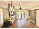 A cozy living room featuring modern lighting, barn door, and sliding glass doors to the outside patio at 717 Cordova Green, Seminole, FL 33777
