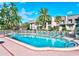 Community swimming pool area with lounge chairs and tropical landscaping at 717 Cordova Green, Seminole, FL 33777