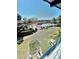 Screened-in porch view showcasing meticulously maintained landscaping and a community pool at 717 Cordova Green, Seminole, FL 33777