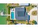 Aerial view of waterfront home with pool, dock, and lush landscaping at 728 Pruitt Dr, Madeira Beach, FL 33708