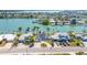 Aerial of waterfront home featuring backyard pool, dock, and front yard at 728 Pruitt Dr, Madeira Beach, FL 33708