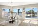 Inviting dining area with water views, modern furniture, and natural light at 728 Pruitt Dr, Madeira Beach, FL 33708