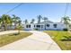 A beautifully landscaped lawn and minimalist design make for a great first impression at 728 Pruitt Dr, Madeira Beach, FL 33708
