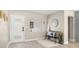Bright foyer featuring a white door, bench seating, and modern decor elements at 728 Pruitt Dr, Madeira Beach, FL 33708