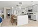 Modern kitchen boasts gray cabinets, stainless steel appliances, and a large island with seating at 728 Pruitt Dr, Madeira Beach, FL 33708
