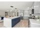Open kitchen featuring an island with blue cabinets and stainless steel appliances at 728 Pruitt Dr, Madeira Beach, FL 33708