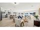 Open-concept living room featuring water views, modern furnishings, and a connected kitchen at 728 Pruitt Dr, Madeira Beach, FL 33708