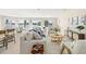 Open-concept living room with water views, modern furniture, and a connected dining area at 728 Pruitt Dr, Madeira Beach, FL 33708
