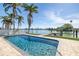 Stunning waterfront home with a pool, dock, and lush landscaping at 728 Pruitt Dr, Madeira Beach, FL 33708