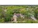 Aerial shot of a home nestled in a lush, green neighborhood with waterfront access, showcasing its serene setting at 8425 Jackson Springs Rd, Tampa, FL 33615