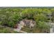 Lush aerial view of a home with waterfront access, showing its ideal location amidst natural beauty at 8425 Jackson Springs Rd, Tampa, FL 33615