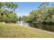 Backyard scene with lush tropical landscaping and river view at 8425 Jackson Springs Rd, Tampa, FL 33615