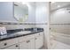 Light and airy bathroom featuring a vanity with decorative accents and a shower/tub combo at 8425 Jackson Springs Rd, Tampa, FL 33615