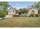 Inviting two-story home with a classic design, featuring a well-manicured lawn and mature landscaping at 8425 Jackson Springs Rd, Tampa, FL 33615