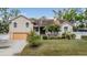 Beautiful two-story house with a well-kept lawn, landscaped garden, and a welcoming front porch at 8425 Jackson Springs Rd, Tampa, FL 33615