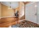Inviting foyer with hardwood floors, a white front door, and a view into the dining area at 8425 Jackson Springs Rd, Tampa, FL 33615