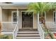 Welcome to this home with a covered front porch, decorative column, and tropical landscaping at 8425 Jackson Springs Rd, Tampa, FL 33615