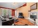 Cozy living room features a fireplace, hardwood floors, and vaulted ceilings at 8425 Jackson Springs Rd, Tampa, FL 33615
