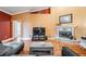 Comfortable living room with hardwood floors, a fireplace, and an entertainment center for media enjoyment at 8425 Jackson Springs Rd, Tampa, FL 33615