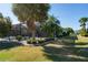 A well-maintained backyard featuring a screened-in lanai and mature palm trees at 1038 Emerald Dunes Dr, Sun City Center, FL 33573
