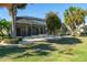 Lovely backyard featuring a screened-in lanai and meticulously maintained landscaping at 1038 Emerald Dunes Dr, Sun City Center, FL 33573