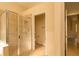 Bathroom featuring a tiled glass shower stall and a separate toilet room at 1038 Emerald Dunes Dr, Sun City Center, FL 33573