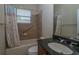 Bathroom featuring shower-tub combo with tile surround, granite vanity and vanity mirror at 1038 Emerald Dunes Dr, Sun City Center, FL 33573