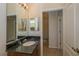 Bathroom showcasing dual mirrors, granite vanity and an adjoining room at 1038 Emerald Dunes Dr, Sun City Center, FL 33573