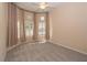 Bedroom featuring neutral carpet and large bay window with plantation shutters at 1038 Emerald Dunes Dr, Sun City Center, FL 33573