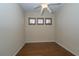 Empty bedroom featuring hardwood floors, light beige walls and shuttered windows at 1038 Emerald Dunes Dr, Sun City Center, FL 33573