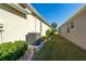 Exterior home shot of side yard with AC unit and garden bed with bushes at 1038 Emerald Dunes Dr, Sun City Center, FL 33573