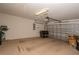 Unfinished garage interior showing concrete floor and partially closed garage door at 1038 Emerald Dunes Dr, Sun City Center, FL 33573