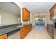 Gourmet kitchen offering breakfast bar and stainless steel appliances with a view to the pool at 1038 Emerald Dunes Dr, Sun City Center, FL 33573